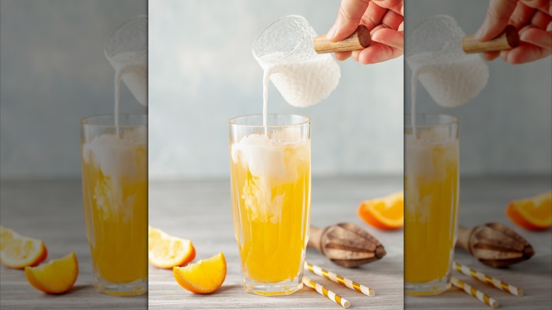 Pouring cream into orange soda