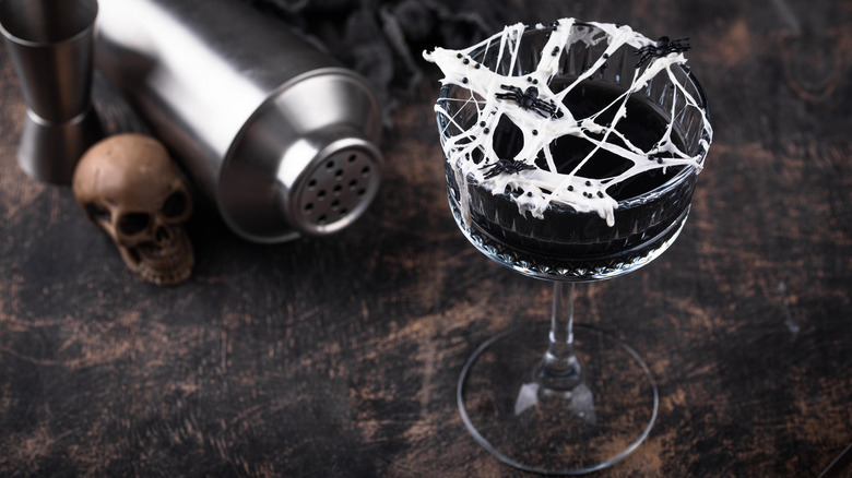 Halloween cocktail with spiderwebs and spiders