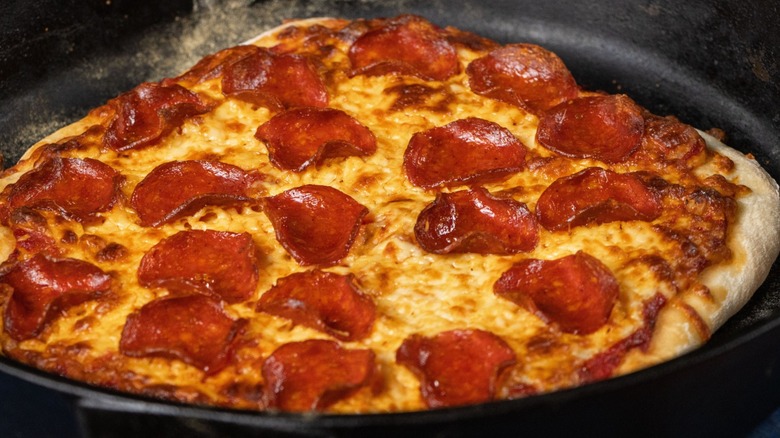 Pepperoni pizza in a cast iron pan.