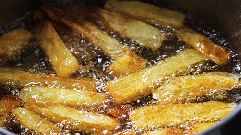 French fries in a pot of hot oil.