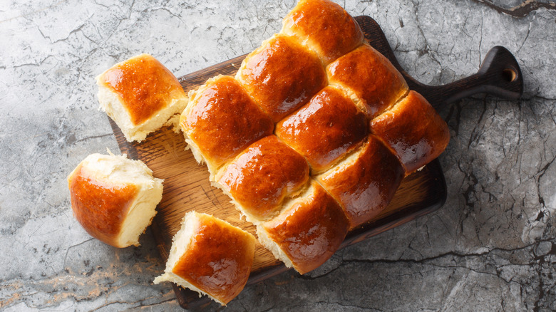 Hawaiian sweet rolls on wooden cutting board