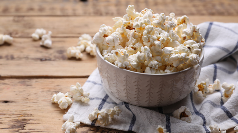 Bowl of popcorn salad with fresh herbs on top