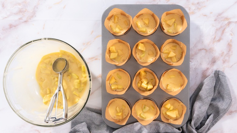 Muffin batter in parchment paper-lined muffin tin