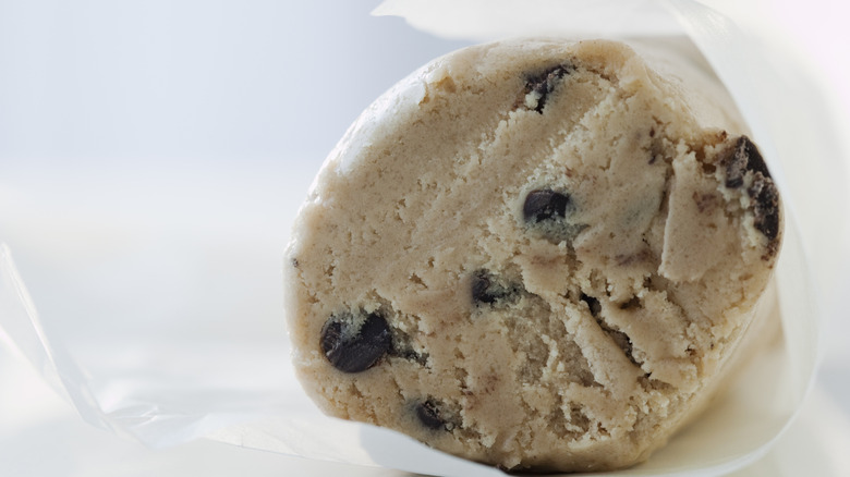 A roll of chocolate chip cookie dough