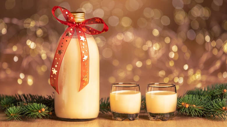 bottled homemade eggnog with two glasses