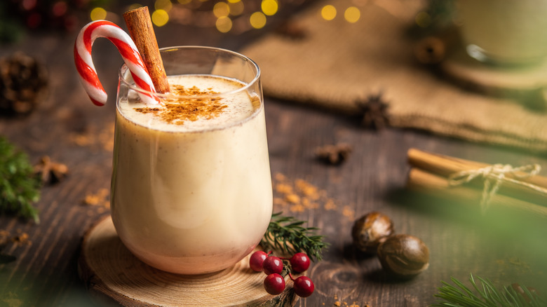 eggnog with cinnamon and candy cane