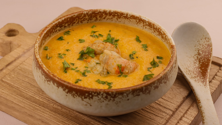 lobster bisque in a beige and brown bowl