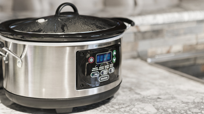 Slow cooker cooking on a counter.