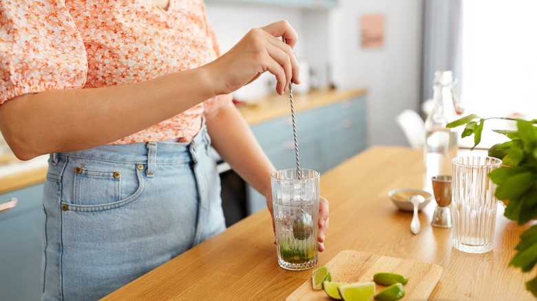 woman stirring cocktail