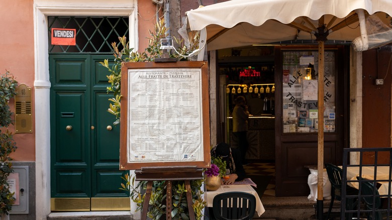 Menu on board in front of small restaurant