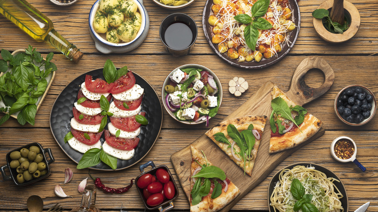 Wood table full of Italian ingredients and dishes