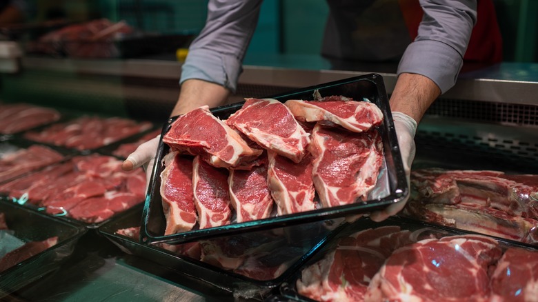 butcher holding meat