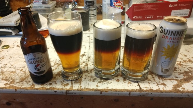 Three black and tan beers on a table.