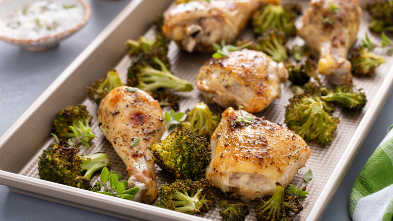 foil-lined pan of baked chicken thighs and broccoli