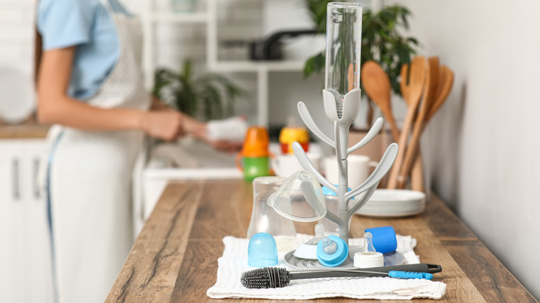 A baby bottle drying rack on a kitchen counter