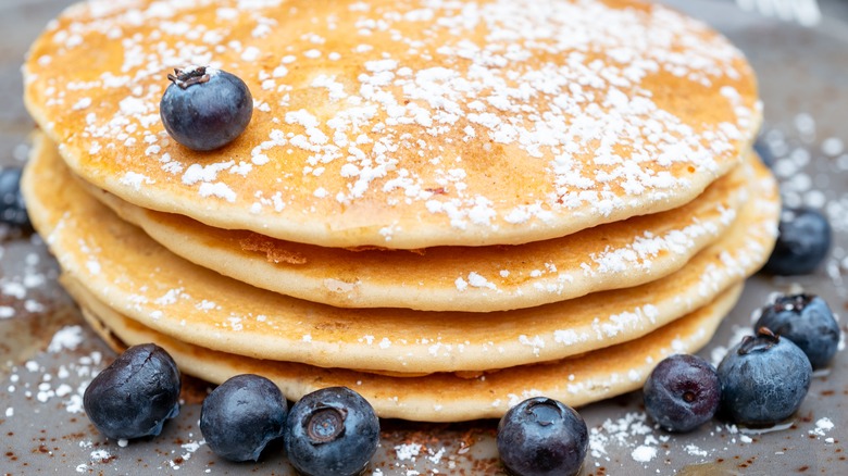 blueberry pancakes with powdered sugar on top