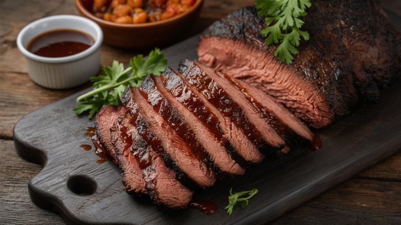 Sliced brisket on a wooden cutting board