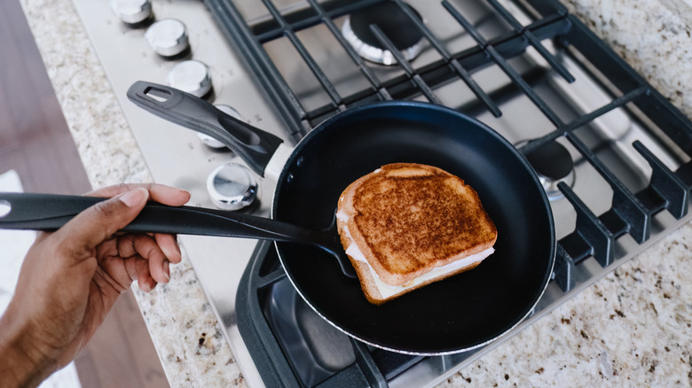 A sandwich on a frying pan.