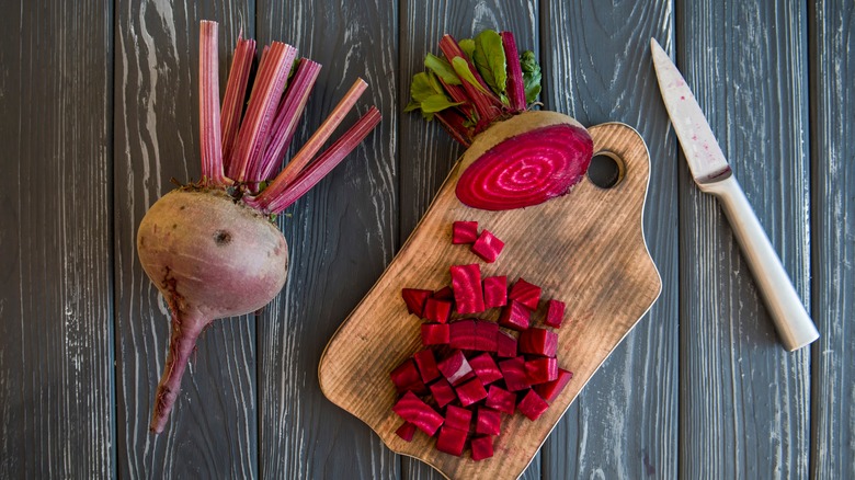 small diced beets on cutting board with knife