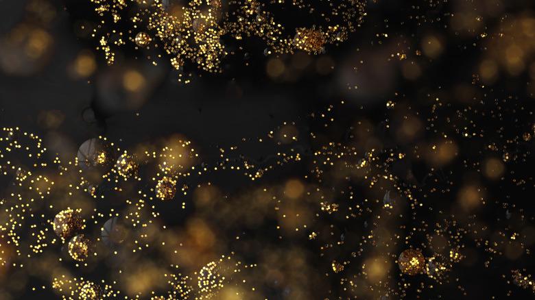 A blurred black background with gold glitter