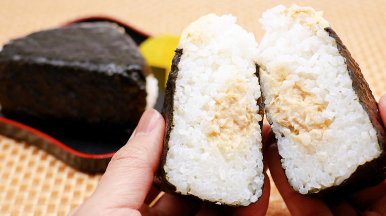 tuna mayo onigiri with someone's thumb