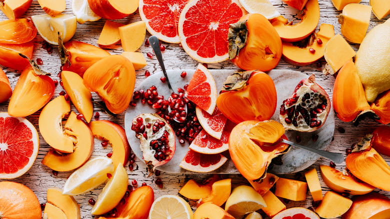 Winter produce including squash, persimmons , and citrus fruits