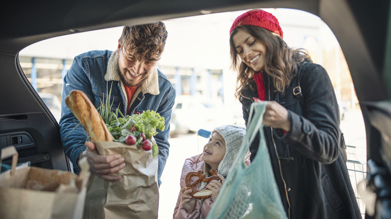 A family grocery shopping in cold weather