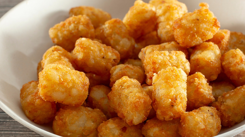 white bowl full of golden tater tots