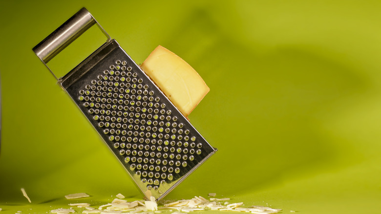 Leaning box grater with cheese against it