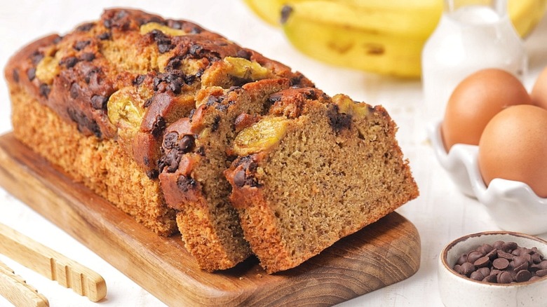 Banana bread cut into slices on a wooden board