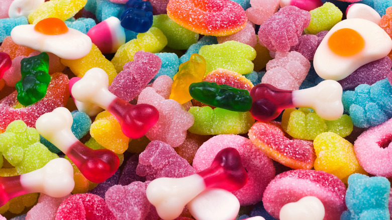 An assorted pile of gummy candy in many colors and shapes