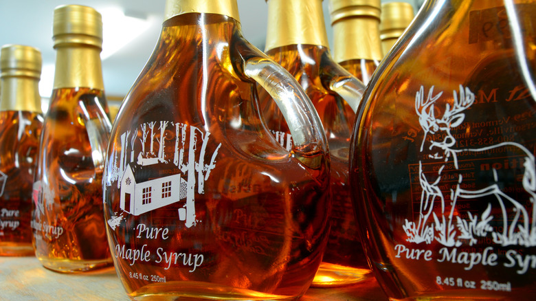 glass bottles of pure maple syrup on a supermarket shelf