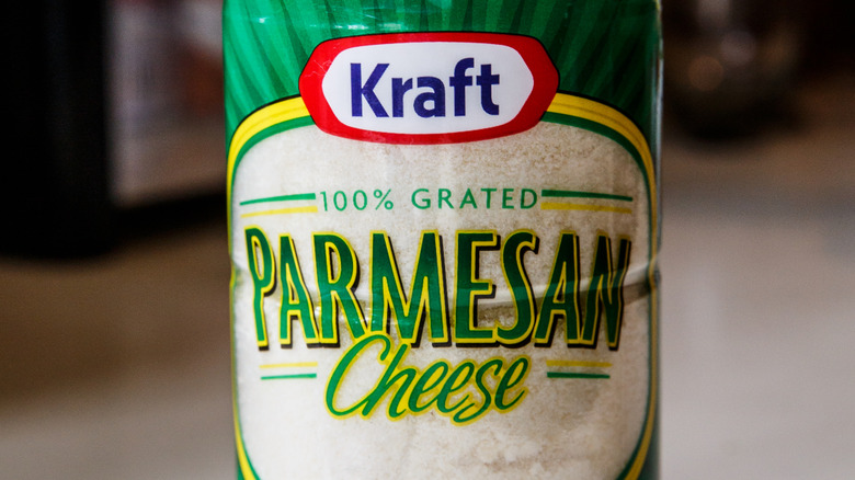 A container of Kraft 100% grated Parmesan cheese