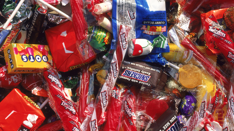 A pile of mini candy pieces including Snickers, Twizzlers, and Dots