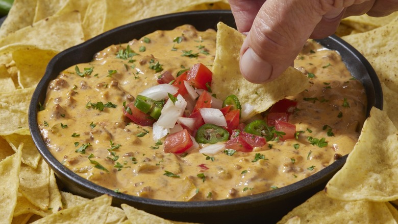 Chili cheese dip surrounded by tortilla chips