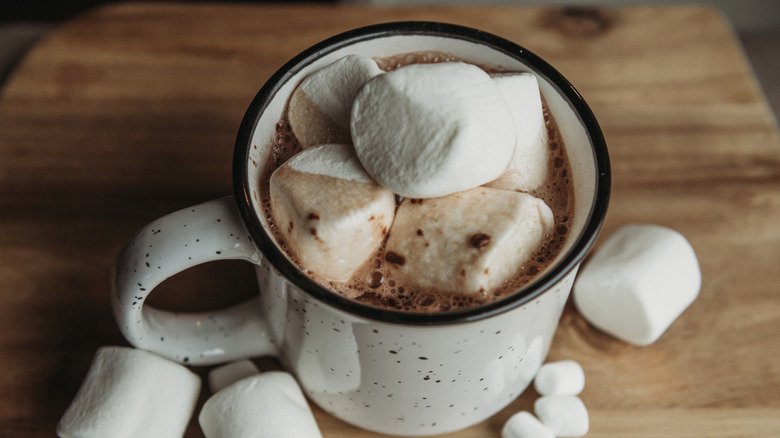 Hot chocolate with large marshmallows on top in a white mug