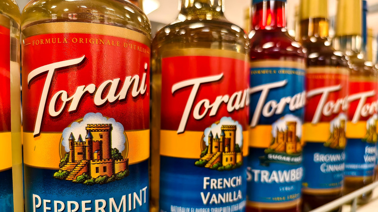 Torani syrup bottles on a shelf in the store