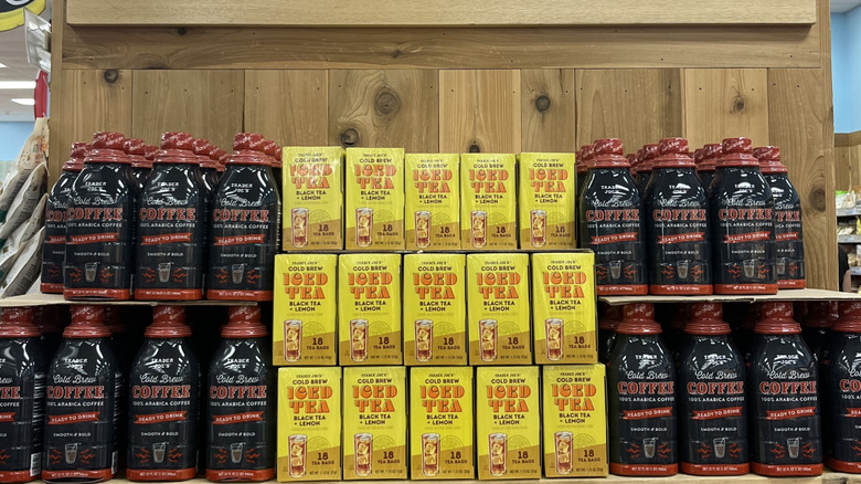 Stacks of Trader Joe's cold brew coffee on wooden shelves