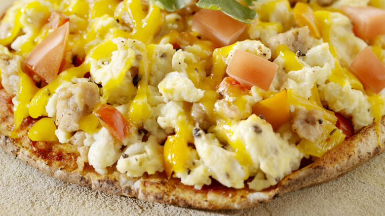 Eggs, cheese, and tomatoes on pizza