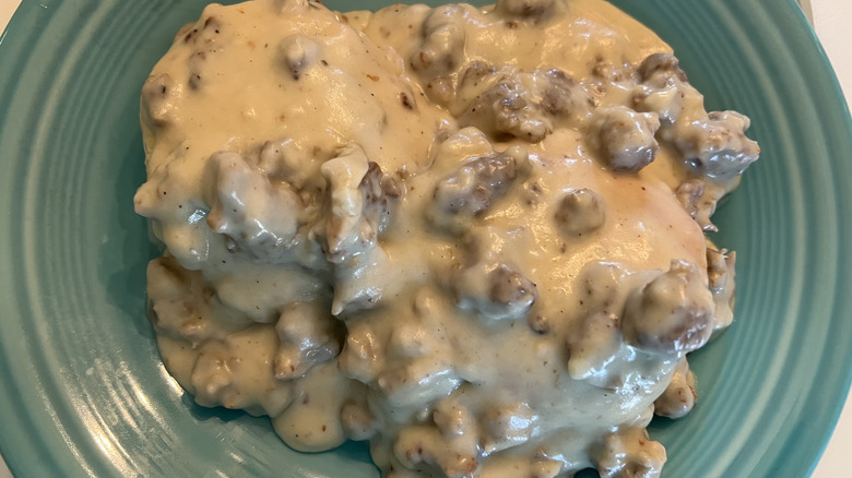 Sausage gravy in shallow blue bowl