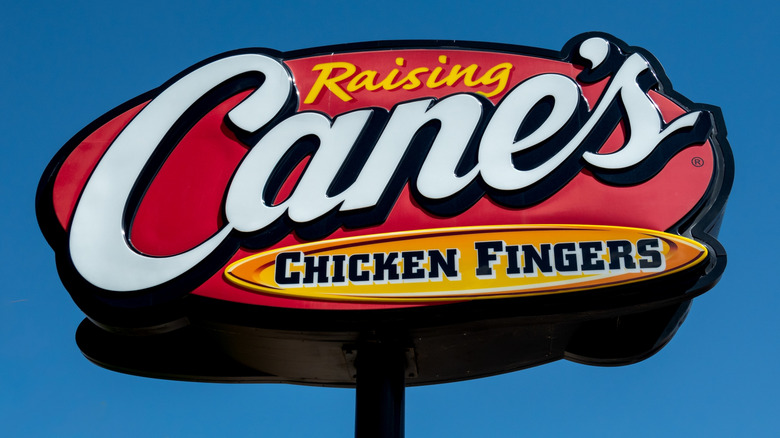 A Raising Cane's sign during the day.