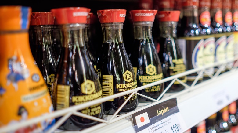 Double spouted Kikkoman soy sauce bottles on a grocery store shelf