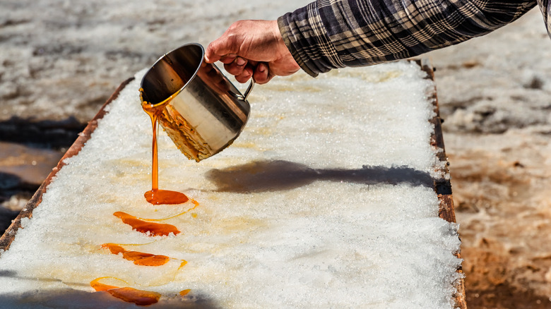 Pouring maple syrup on top of ice