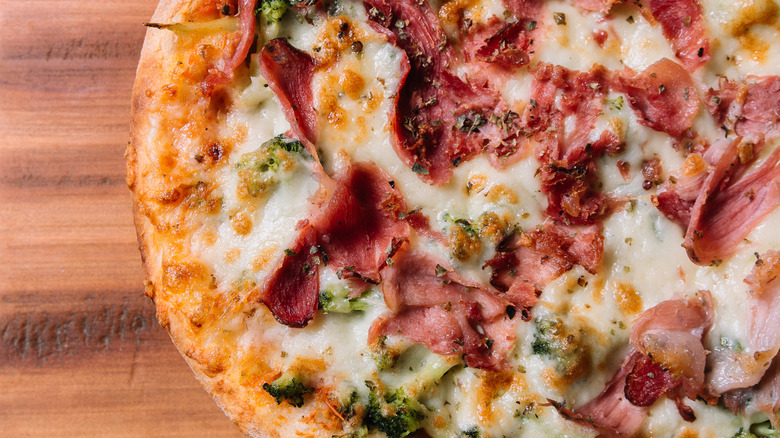 overhead shot of california pizza on wooden cutting board