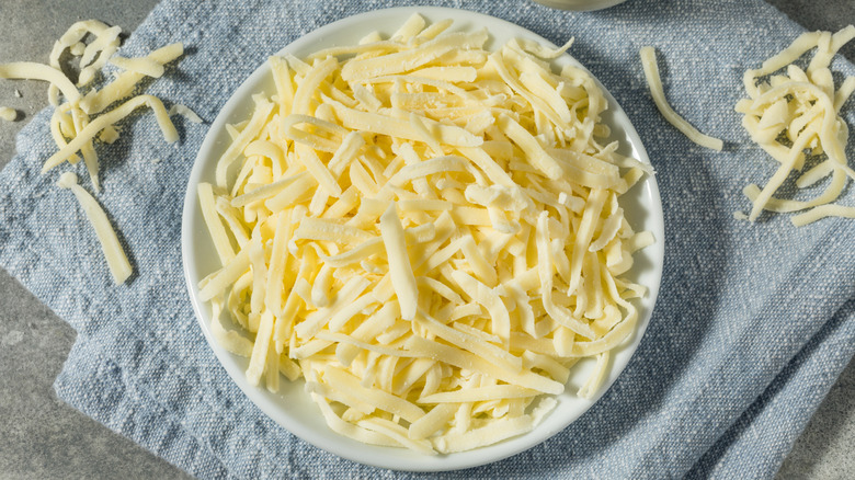 Shredded cheese on a white plate