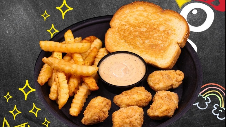 Huey Magoo's bite-sized chicken tenders with fries on plate