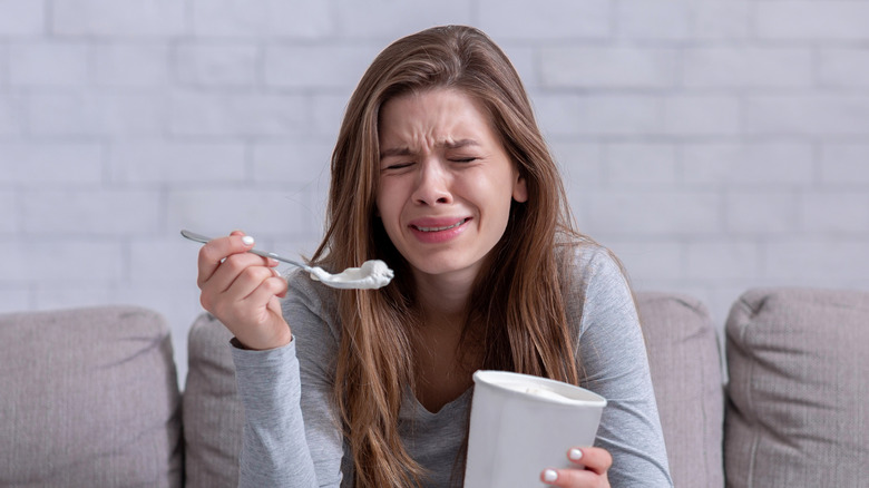 Person experiencing distress while eating ice cream