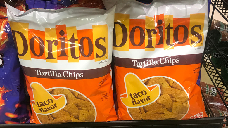 bags of Doritos taco flavor chips on grocery shelf