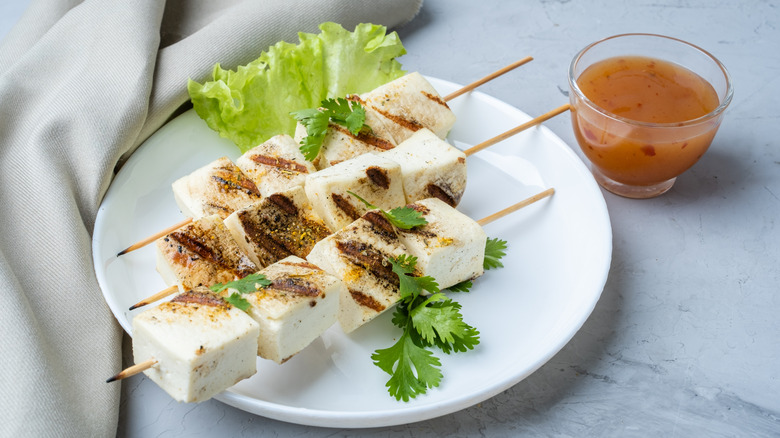 grilled tofu on skewers with dipping sauce