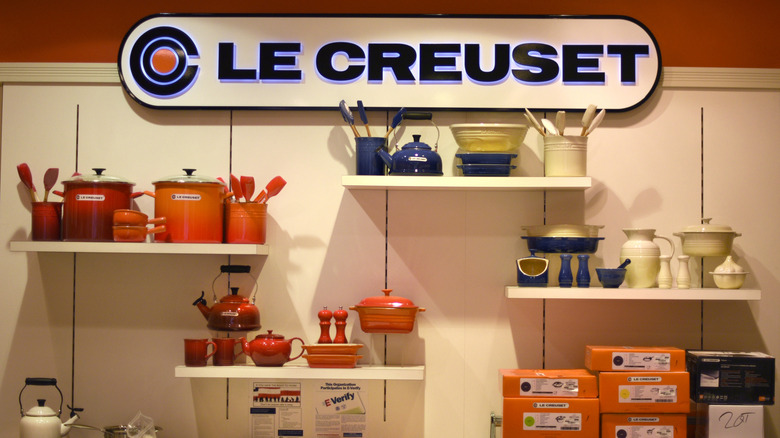 Le Creuset pots, pans, and other kitchen items in store display